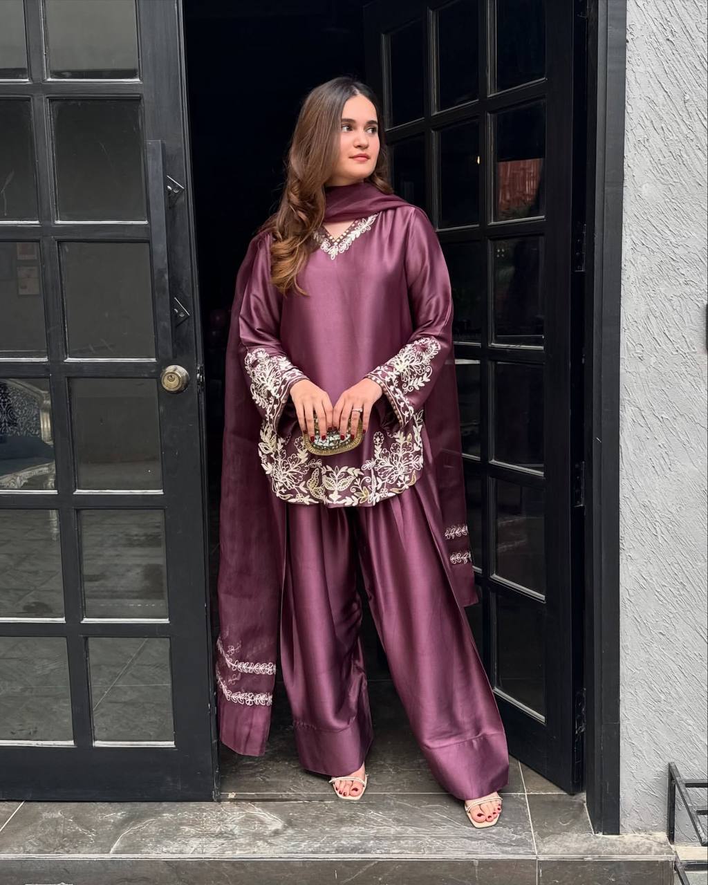 Majestic Aura: Woman in Wine Captivates at the Doorway