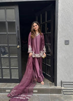 Majestic Aura: Woman in Wine Captivates at the Doorway