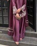 Majestic Aura: Woman in Wine Captivates at the Doorway