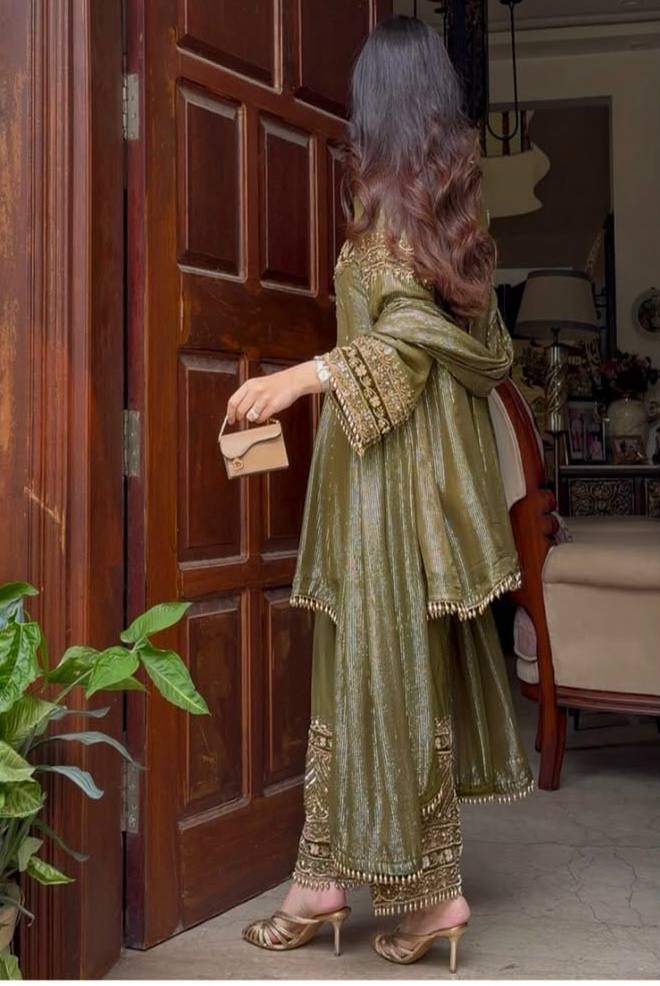 An opulent olive green ensemble that radiates timeless elegance