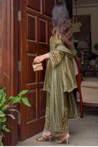 An opulent olive green ensemble that radiates timeless elegance