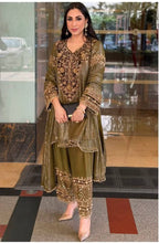 An opulent olive green ensemble that radiates timeless elegance